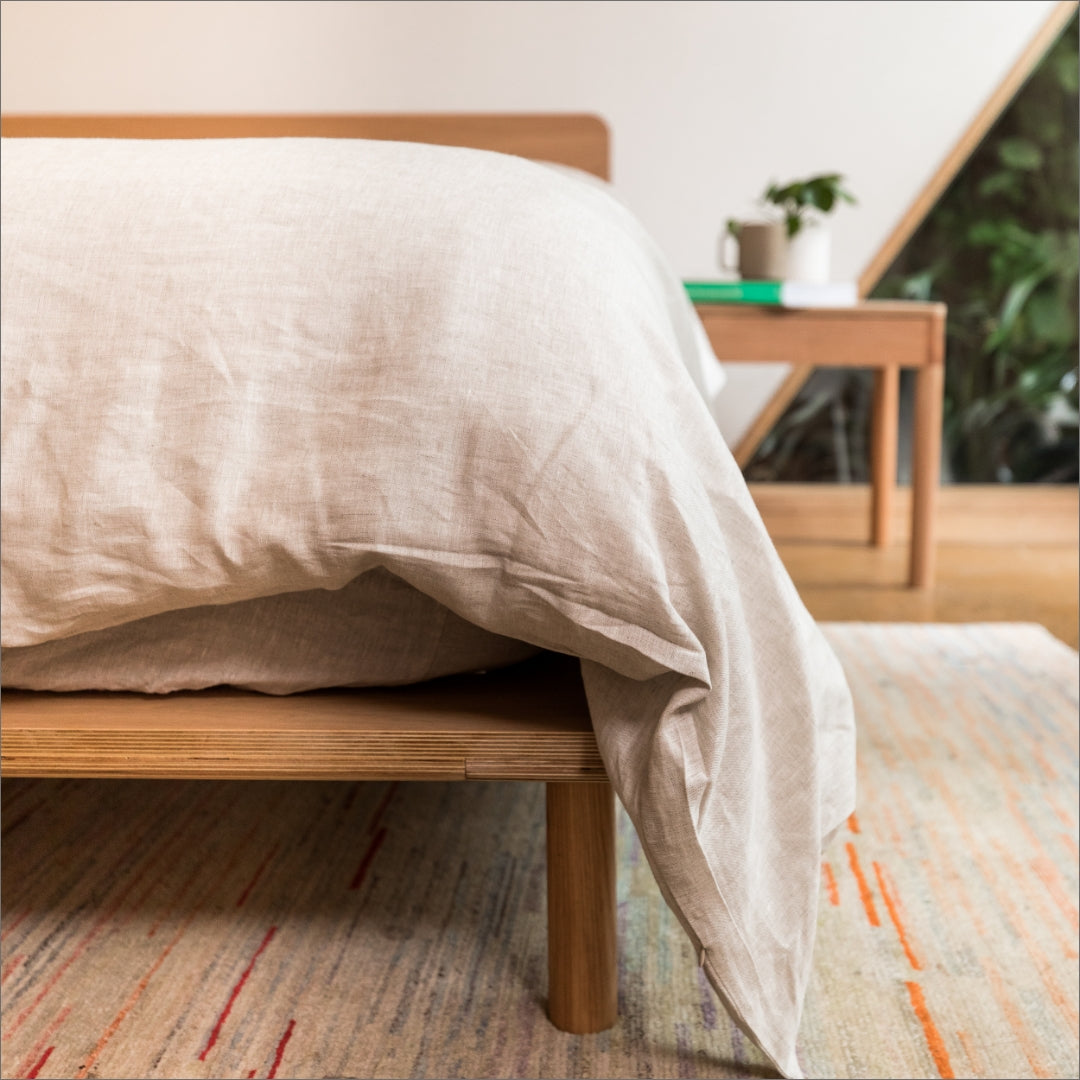 Angle of Timber Bed Frame topped by the Eva Mattress and Eva's Hemp Linen | {"option1":["Comfort Classic Mattress"]}